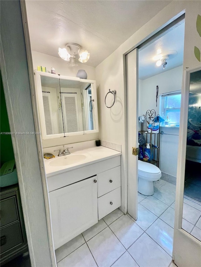 2465 NE 15th Ave, Pompano Beach, FL 33064 - bathroom with toilet, vanity, and tile patterned flooring