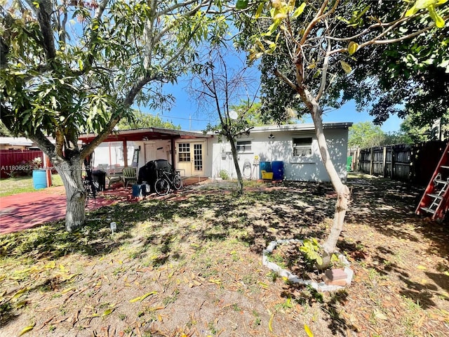 2465 NE 15th Ave, Pompano Beach, FL 33064 - rear view of property with a fenced backyard and a patio