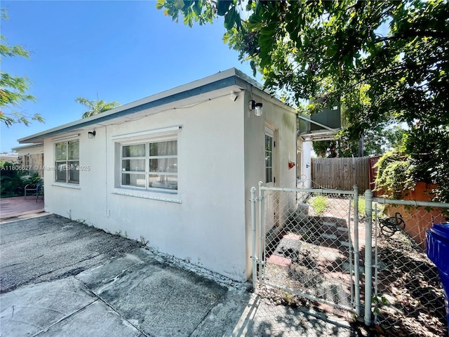 2465 NE 15th Ave, Pompano Beach, FL 33064 - view of property exterior featuring a gate and stucco siding