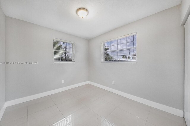 610 Snowden Dr, Lake Worth, FL 33461 - unfurnished room featuring baseboards and tile patterned flooring
