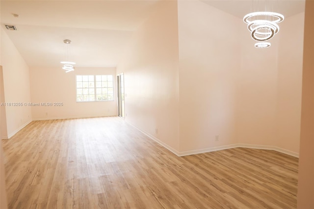 5293 Buckhead Cir Unit 2030, Boca Raton, FL 33486 - empty room featuring a chandelier, light wood-style floors, and baseboards