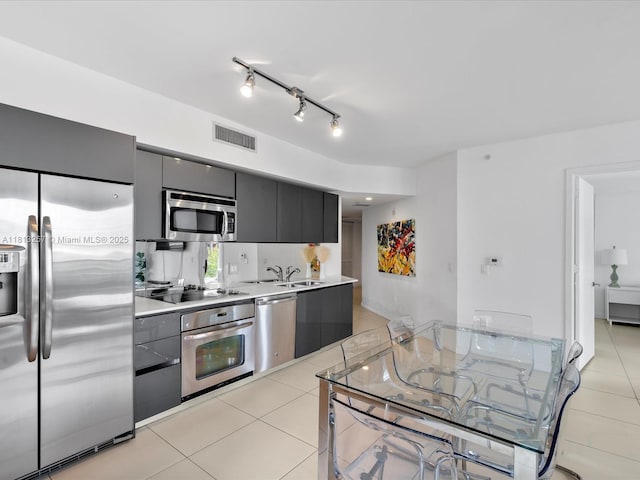 31 SE 6th St Unit 802, Miami, FL 33131 - kitchen featuring stainless steel appliances, light tile patterned floors, light countertops, gray cabinets, and a sink