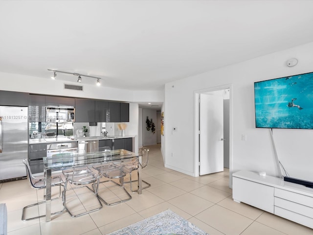 31 SE 6th St Unit 802, Miami, FL 33131 - kitchen featuring appliances with stainless steel finishes, light countertops, modern cabinets, and light tile patterned floors