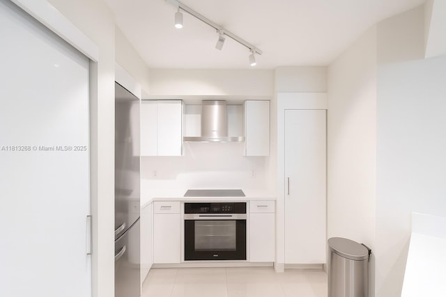 9201 Collins Ave Unit 624, Surfside, FL 33154 - kitchen with oven, wall chimney range hood, white cabinets, stovetop, and light countertops
