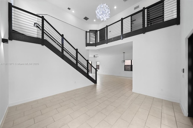 15924 SW 136th Way, Miami, FL 33196 - unfurnished living room with a high ceiling, recessed lighting, stairway, and a chandelier