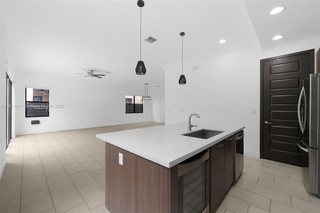 15924 SW 136th Way, Miami, FL 33196 - kitchen with wine cooler, freestanding refrigerator, light tile patterned floors, a kitchen island with sink, and recessed lighting