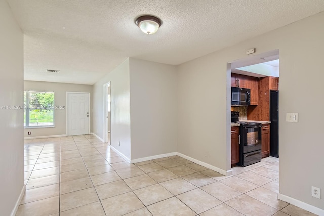 766 NW 35th Ave, Lauderhill, FL 33311 - unfurnished room with light tile patterned floors, a textured ceiling, and baseboards