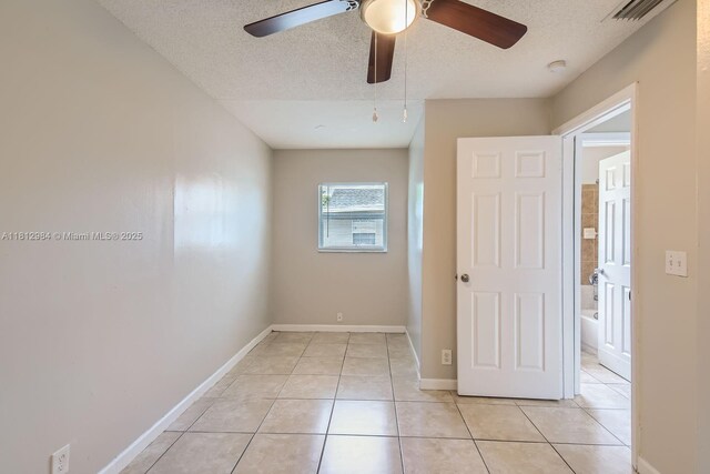 766 NW 35th Ave, Lauderhill, FL 33311 - unfurnished bedroom featuring a textured ceiling, light tile patterned floors, baseboards, and a ceiling fan
