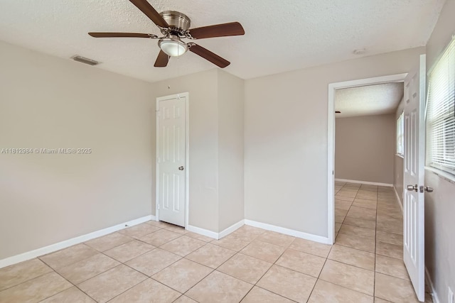 766 NW 35th Ave, Lauderhill, FL 33311 - empty room featuring a textured ceiling, light tile patterned floors, ceiling fan, and baseboards
