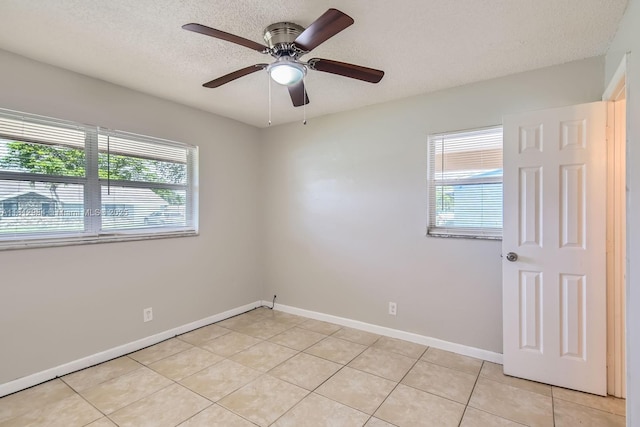 766 NW 35th Ave, Lauderhill, FL 33311 - empty room with plenty of natural light, light tile patterned floors, baseboards, and a textured ceiling
