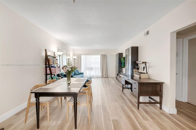 733 NW 30th Ct Unit 2, Wilton Manors, FL 33311 - dining area with light wood-type flooring and baseboards