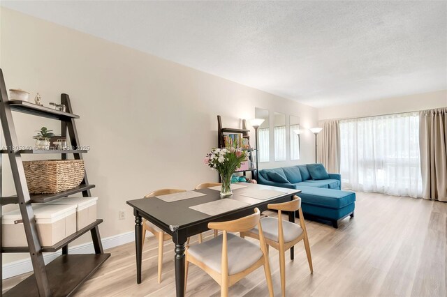 733 NW 30th Ct Unit 2, Wilton Manors, FL 33311 - dining room featuring light wood-style flooring, a textured ceiling, and baseboards