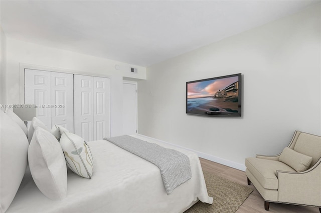 733 NW 30th Ct Unit 2, Wilton Manors, FL 33311 - bedroom with wood finished floors, a closet, and baseboards