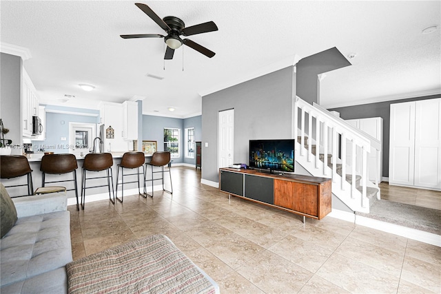 17473 SW 22nd St, Miramar, FL 33029 - living area with ornamental molding, stairway, ceiling fan, and baseboards