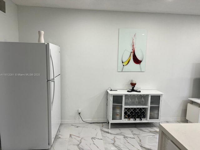 2905 Pierce St Unit 7, Hollywood, FL 33020 - kitchen with freestanding refrigerator, light marble finish flooring, light countertops, and baseboards