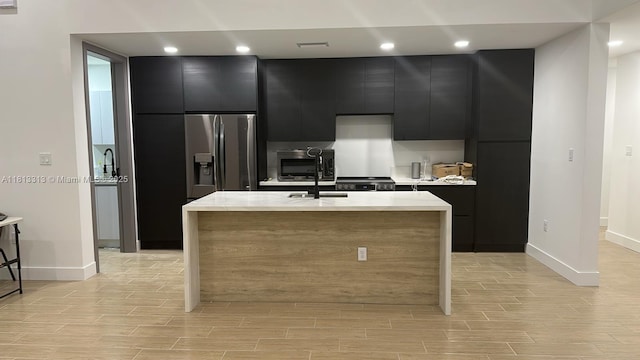 14074 Whittier Prt, Charlotte, FL 33981 - kitchen featuring dark cabinetry, stainless steel refrigerator with ice dispenser, baseboards, light countertops, and recessed lighting