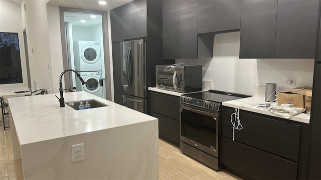 14074 Whittier Prt, Charlotte, FL 33981 - kitchen featuring appliances with stainless steel finishes, dark cabinetry, modern cabinets, a sink, and recessed lighting