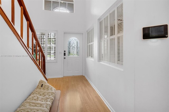 9280 Boca Gardens Pkwy Unit B, Boca Raton, FL 33496 - living room with a high ceiling, wood finished floors, ceiling fan, and baseboards