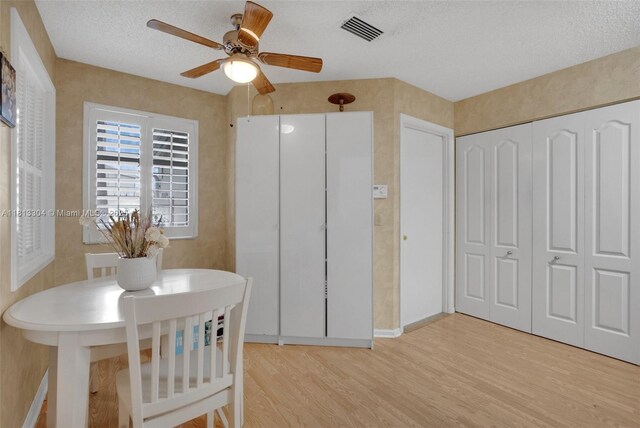 9280 Boca Gardens Pkwy Unit B, Boca Raton, FL 33496 - kitchen featuring black appliances, white cabinets, light wood-style flooring, a textured ceiling, and light stone counters