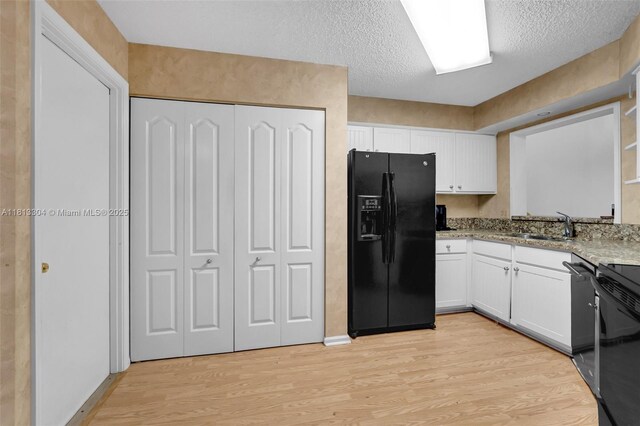 9280 Boca Gardens Pkwy Unit B, Boca Raton, FL 33496 - kitchen with black appliances, light wood finished floors, a sink, and white cabinets