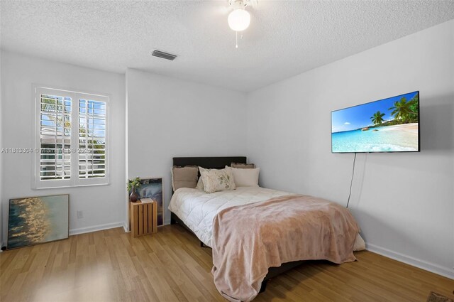 9280 Boca Gardens Pkwy Unit B, Boca Raton, FL 33496 - bedroom featuring wood finished floors, a textured ceiling, and baseboards