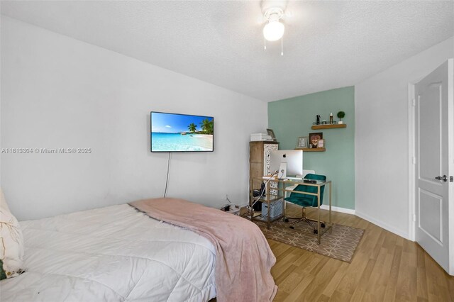 9280 Boca Gardens Pkwy Unit B, Boca Raton, FL 33496 - bedroom featuring wood finished floors, an office area, a ceiling fan, a textured ceiling, and baseboards