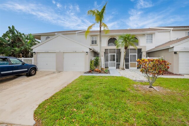 9280 Boca Gardens Pkwy Unit B, Boca Raton, FL 33496 - view of front of property with an attached garage, concrete driveway, and a front yard