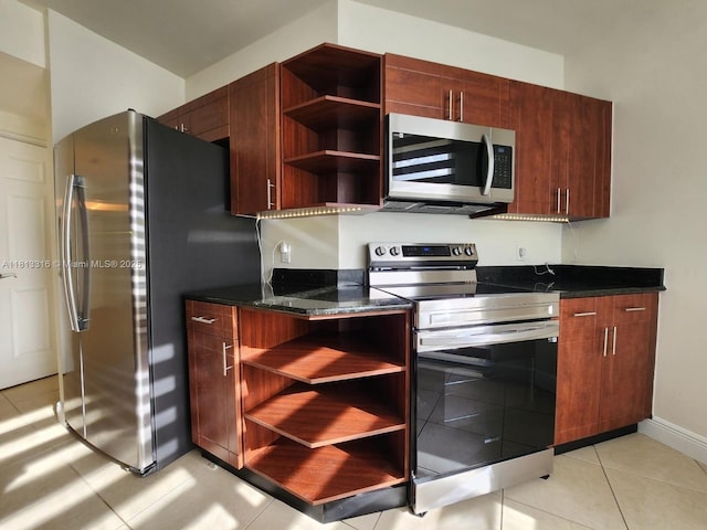 2425 SW 27th Ave Unit 705, Miami, FL 33145 - kitchen featuring stainless steel appliances, open shelves, light tile patterned floors, dark stone countertops, and baseboards