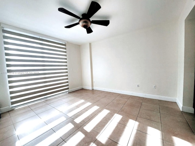 2425 SW 27th Ave Unit 705, Miami, FL 33145 - spare room featuring tile patterned floors, a ceiling fan, and baseboards