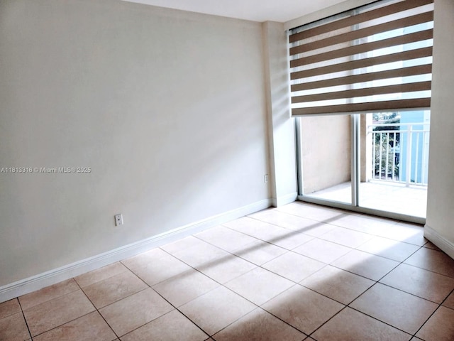 2425 SW 27th Ave Unit 705, Miami, FL 33145 - spare room with baseboards and light tile patterned floors