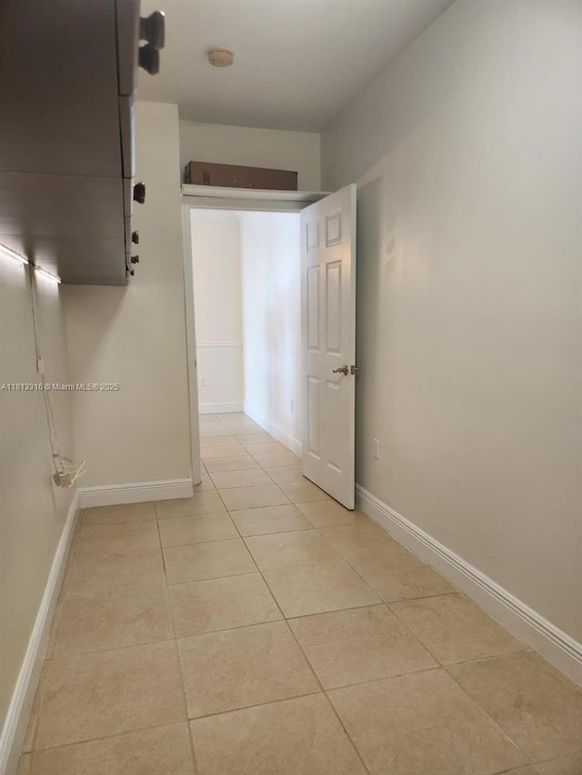 2425 SW 27th Ave Unit 705, Miami, FL 33145 - hallway featuring light tile patterned floors and baseboards