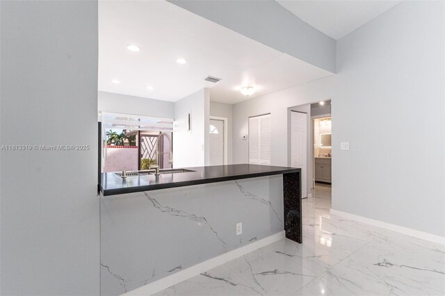9234 Wedgewood Ln Unit D7, Tamarac, FL 33321 - kitchen featuring light marble finish flooring, baseboards, recessed lighting, and dark stone countertops