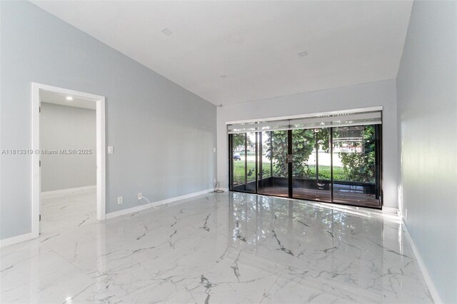 9234 Wedgewood Ln Unit D7, Tamarac, FL 33321 - spare room featuring marble tiled floors, lofted ceiling, and baseboards