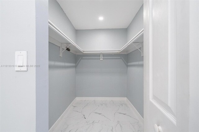 9234 Wedgewood Ln Unit D7, Tamarac, FL 33321 - walk in closet featuring marble finish flooring