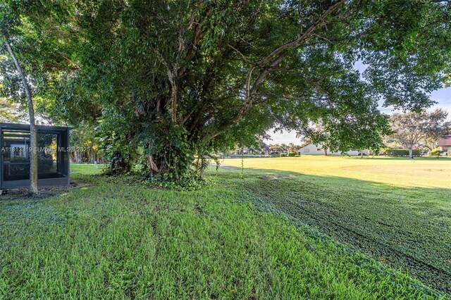 9234 Wedgewood Ln Unit D7, Tamarac, FL 33321 - view of grassy yard featuring a sunroom
