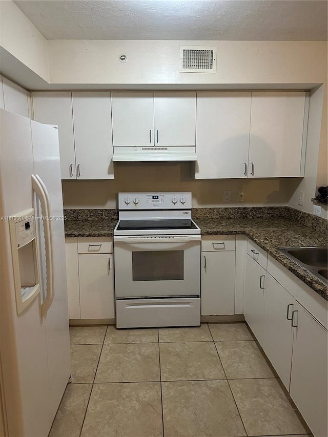 4828 N State Road 7 Unit 8107, Coconut Creek, FL 33073 - kitchen with white appliances, under cabinet range hood, white cabinets, a sink, and light tile patterned flooring