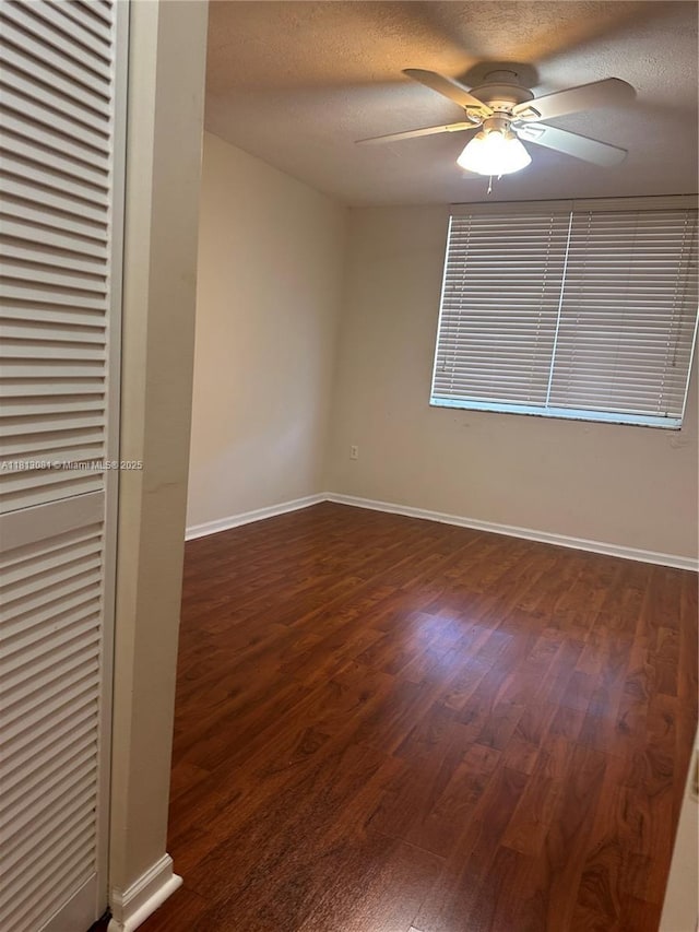 4828 N State Road 7 Unit 8107, Coconut Creek, FL 33073 - spare room featuring dark wood-style floors, a ceiling fan, baseboards, and a textured ceiling