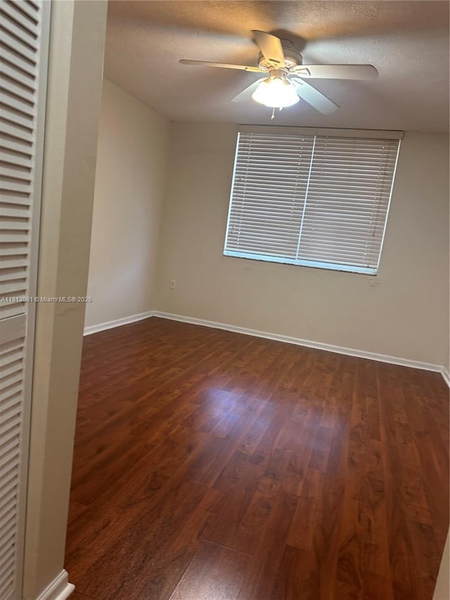 4828 N State Road 7 Unit 8107, Coconut Creek, FL 33073 - unfurnished room featuring dark wood finished floors, a ceiling fan, baseboards, and a textured ceiling