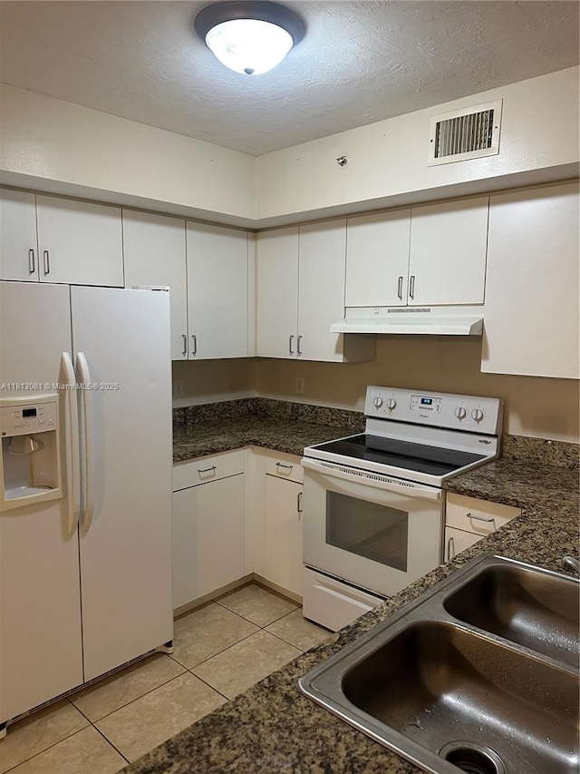 4828 N State Road 7 Unit 8107, Coconut Creek, FL 33073 - kitchen featuring white appliances, under cabinet range hood, a sink, light tile patterned flooring, and white cabinetry