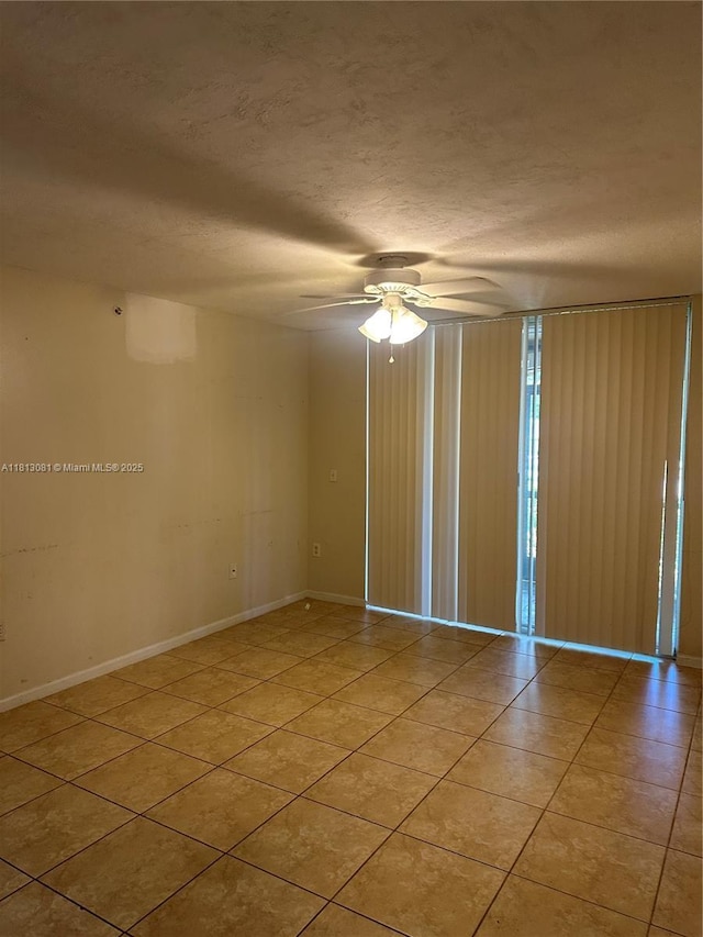 4828 N State Road 7 Unit 8107, Coconut Creek, FL 33073 - unfurnished room with light tile patterned floors, a ceiling fan, a textured ceiling, and baseboards