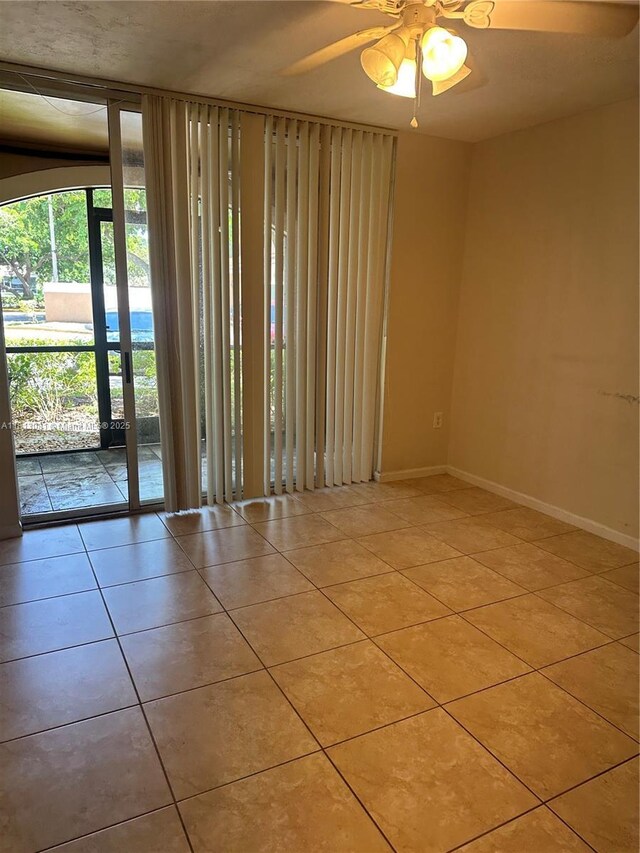 4828 N State Road 7 Unit 8107, Coconut Creek, FL 33073 - empty room featuring tile patterned flooring, a ceiling fan, and baseboards