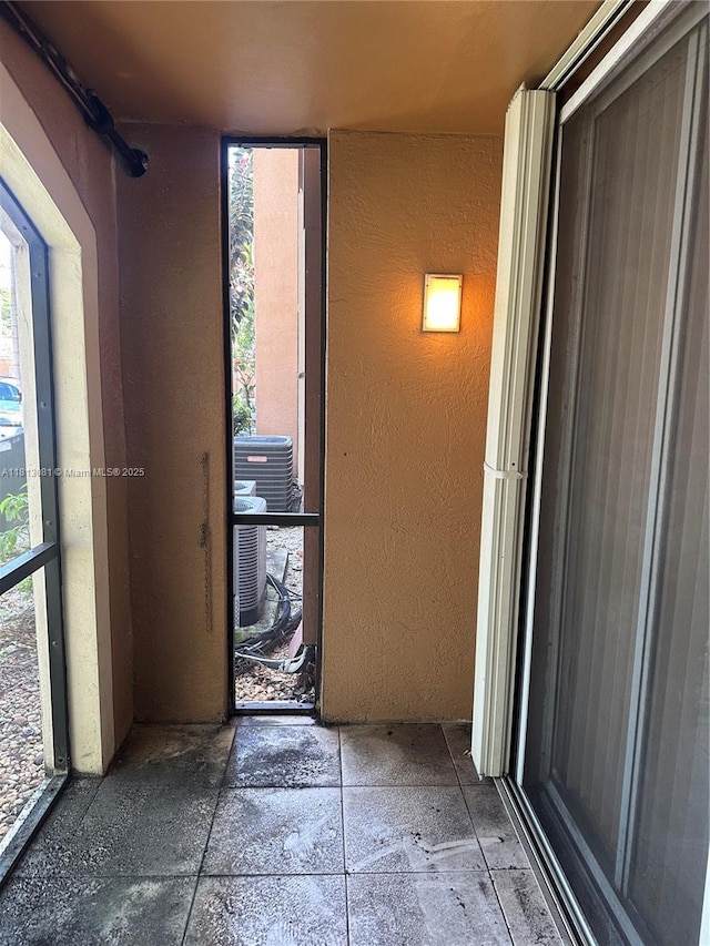 4828 N State Road 7 Unit 8107, Coconut Creek, FL 33073 - hallway featuring healthy amount of natural light and a textured wall