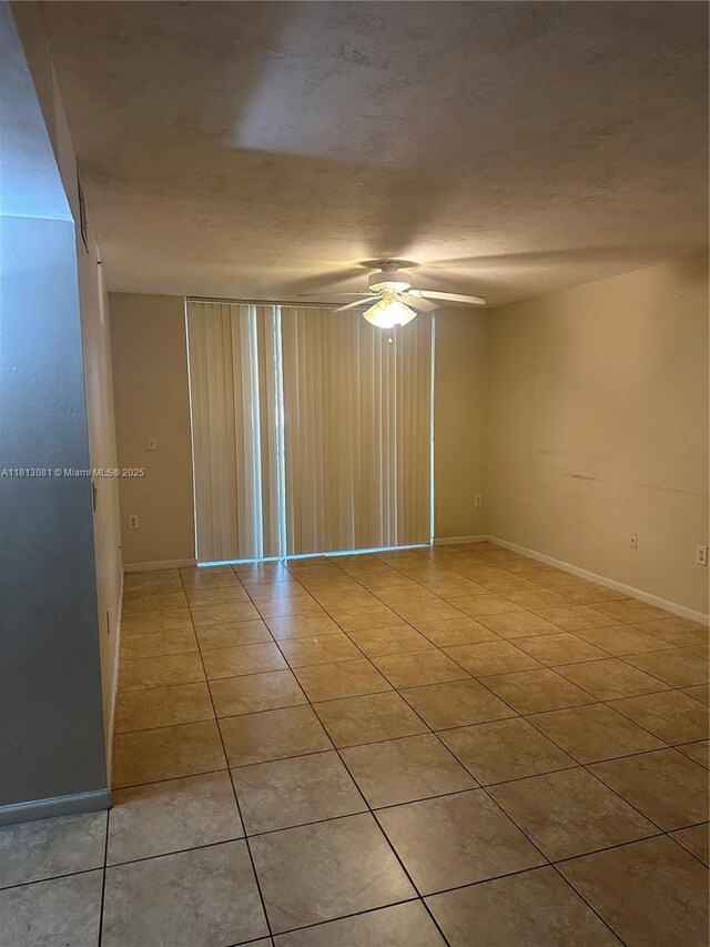4828 N State Road 7 Unit 8107, Coconut Creek, FL 33073 - empty room with a ceiling fan, light tile patterned floors, and baseboards