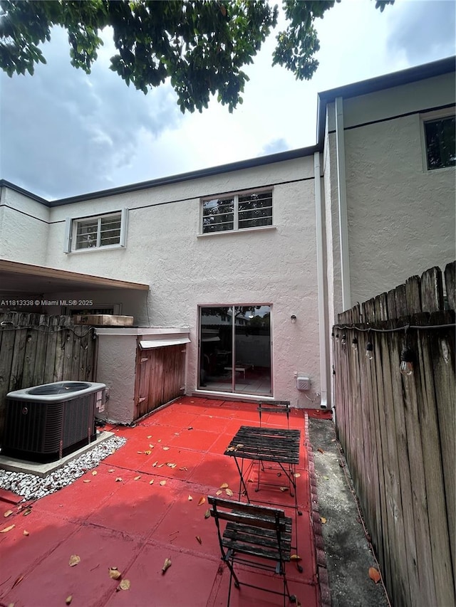 8014 SW 151st Ct Unit 607, Miami, FL 33193 - back of property with stucco siding, cooling unit, and a patio