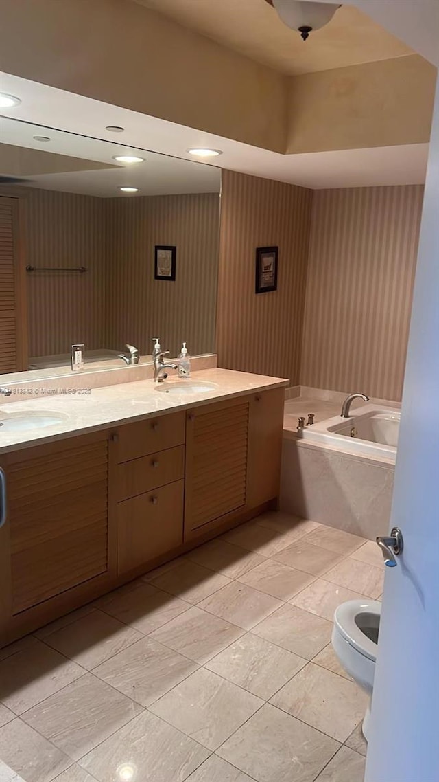 16500 Collins Ave Unit 652, Sunny Isles Beach, FL 33160 - bathroom featuring double vanity, a garden tub, tile patterned floors, and wallpapered walls
