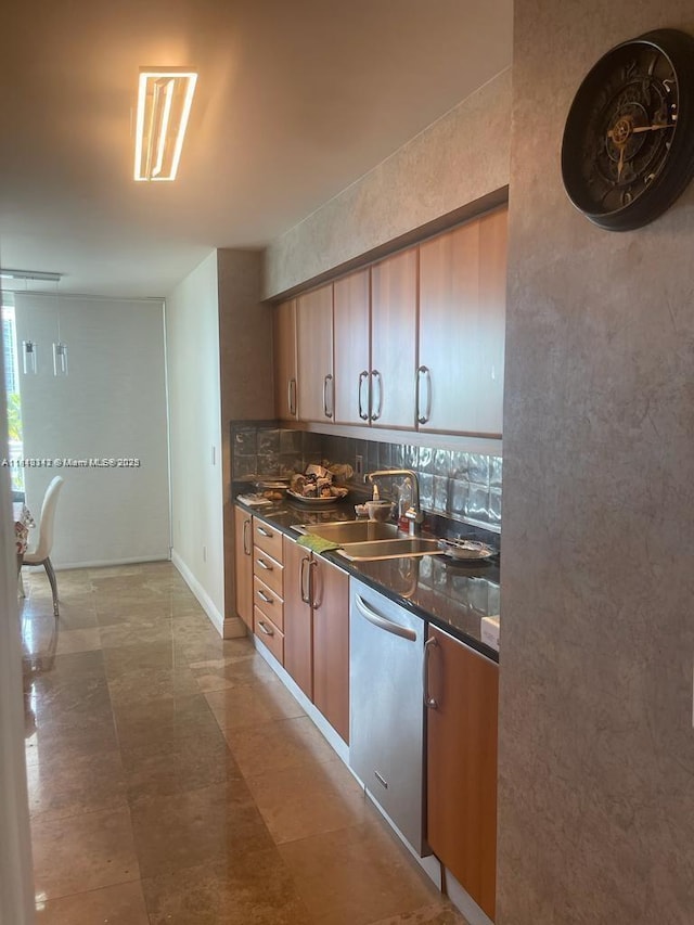 16500 Collins Ave Unit 652, Sunny Isles Beach, FL 33160 - kitchen with a sink, stainless steel dishwasher, dark countertops, and brown cabinets