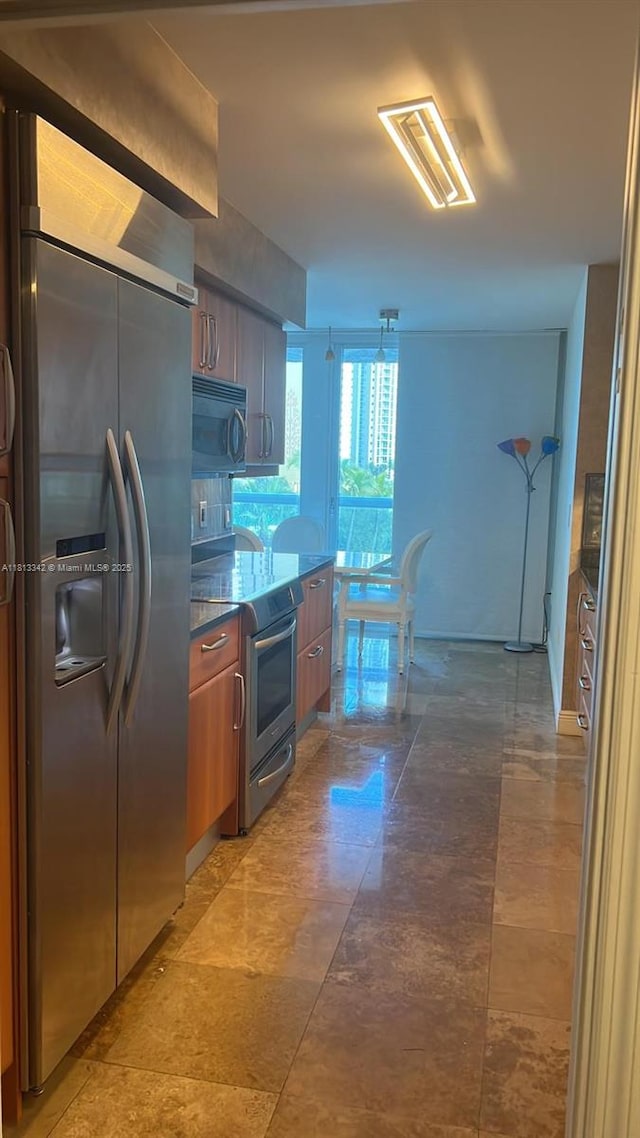 16500 Collins Ave Unit 652, Sunny Isles Beach, FL 33160 - kitchen featuring refrigerator with ice dispenser, stainless steel range with electric cooktop, and dark stone counters