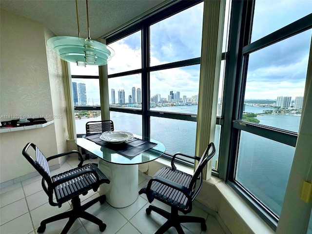 3530 Mystic Pointe Dr Unit 3001, Aventura, FL 33180 - dining space featuring a skyline view, a water view, plenty of natural light, floor to ceiling windows, and tile patterned floors