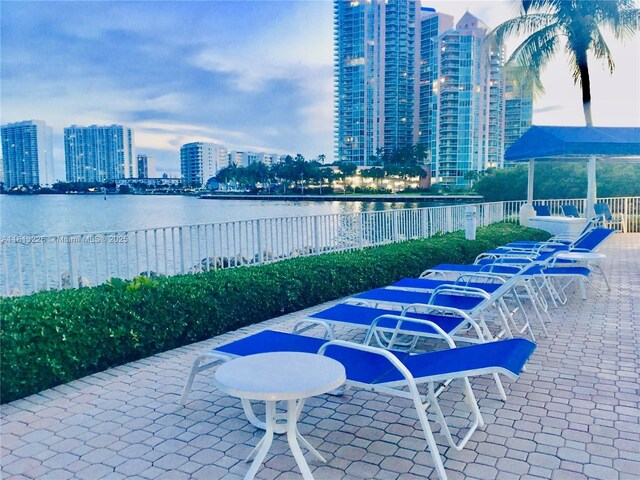 3530 Mystic Pointe Dr Unit 3001, Aventura, FL 33180 - view of patio / terrace with a view of skyline, a water view, and outdoor dining area