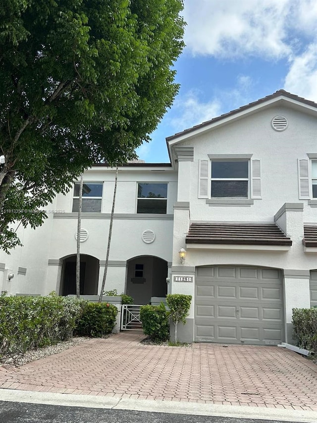 11281 NW 42nd Ter Unit 0, Doral, FL 33178 - view of front of home with decorative driveway, stucco siding, and a garage